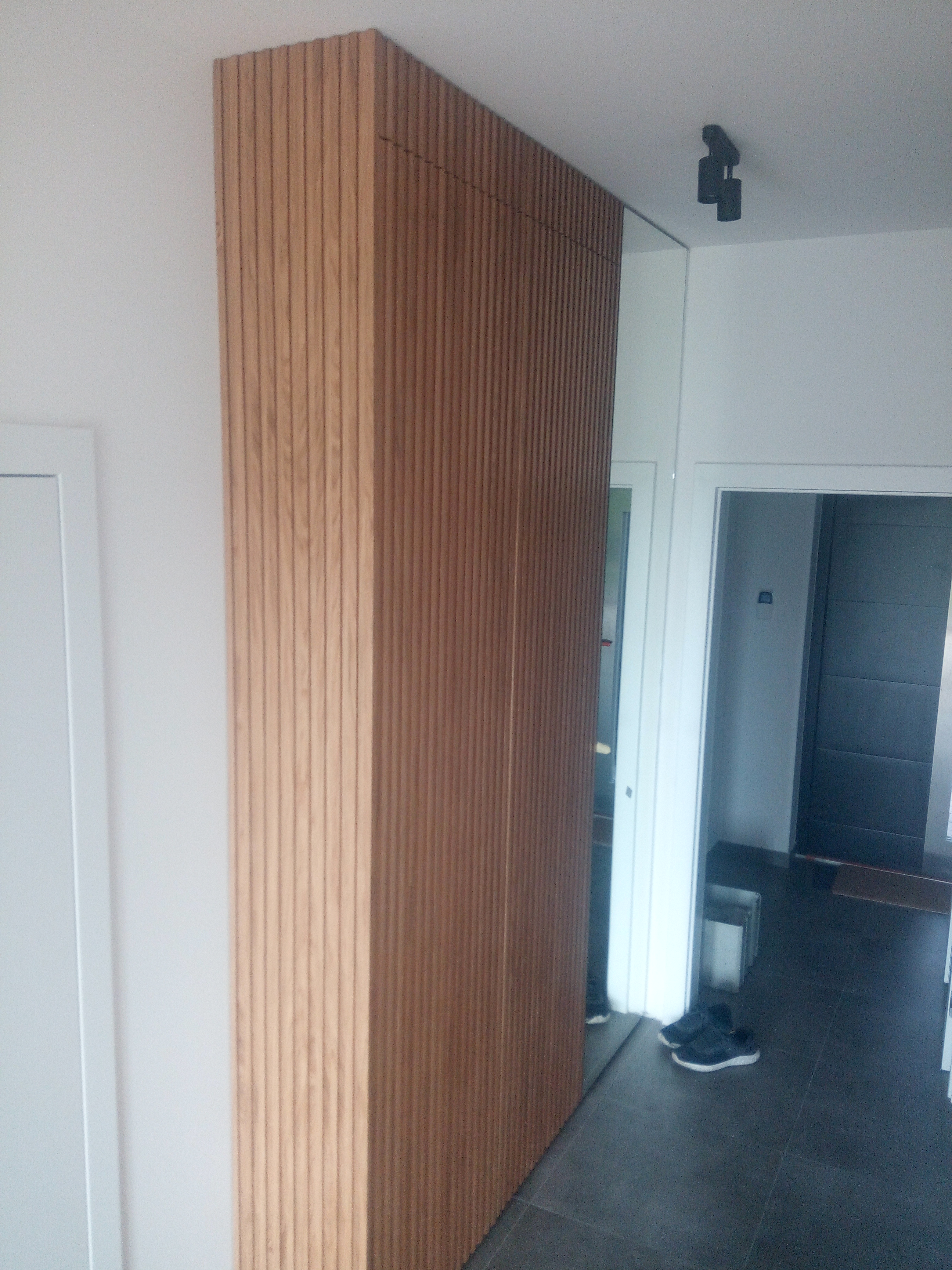 Zabudowa w przedpokoju z lamelami drewnianymi